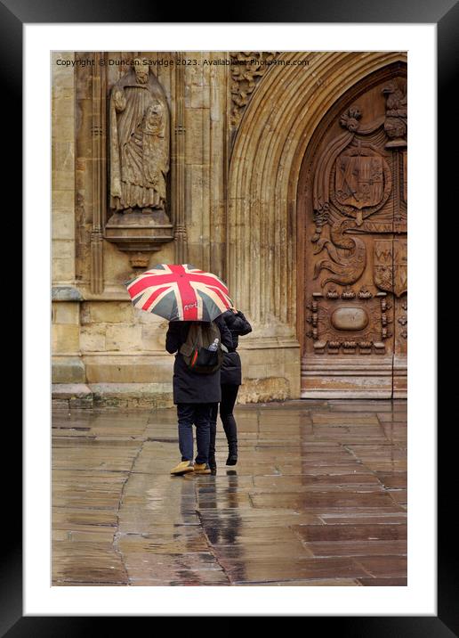 Union jack umbrella outside Bath Abbey Framed Mounted Print by Duncan Savidge