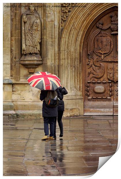Union jack umbrella outside Bath Abbey Print by Duncan Savidge