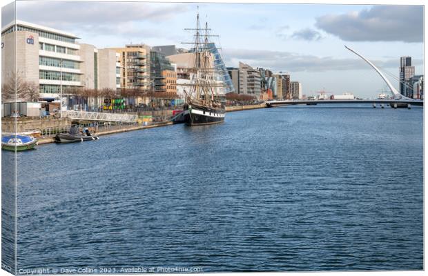 Tall Ship replica, Jeanie Johnston moored on the River Liffey and the river front buildings, Dublin, Ireland Canvas Print by Dave Collins