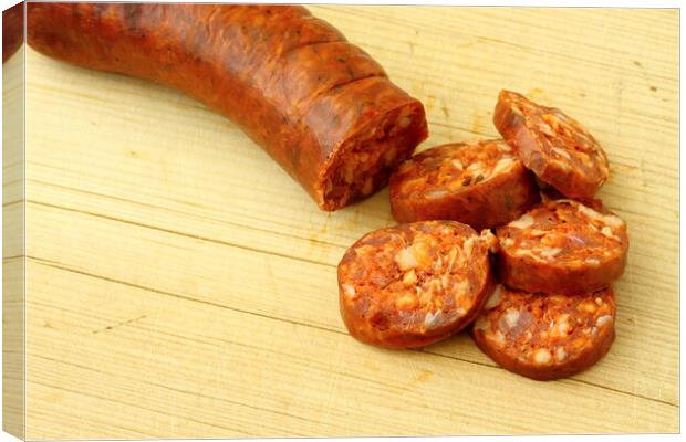 A wooden cutting board and a sausage Canvas Print by Irena Chlubna