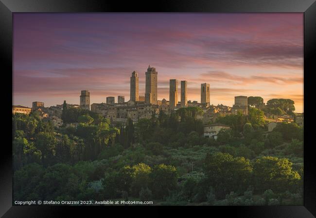 The towers of the village of San Gimignano at sunset. Tuscany, Italy Framed Print by Stefano Orazzini