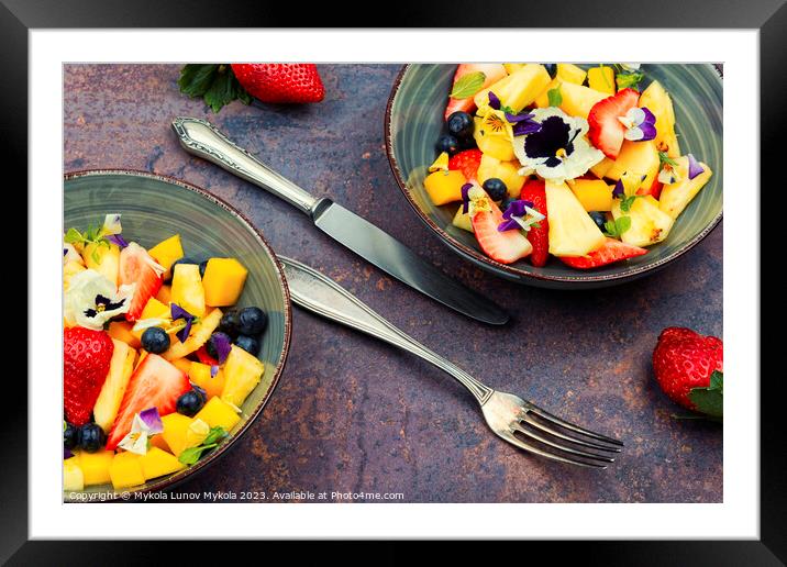 Bright fruit salad with edible flowers. Framed Mounted Print by Mykola Lunov Mykola