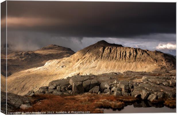 Approaching weather on Bowfell  Canvas Print by John Henderson