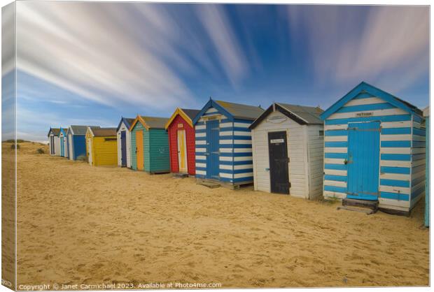 Golden Sands and Rainbow Sheds Canvas Print by Janet Carmichael