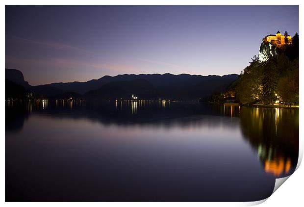 View across Lake Bled at dusk Print by Ian Middleton