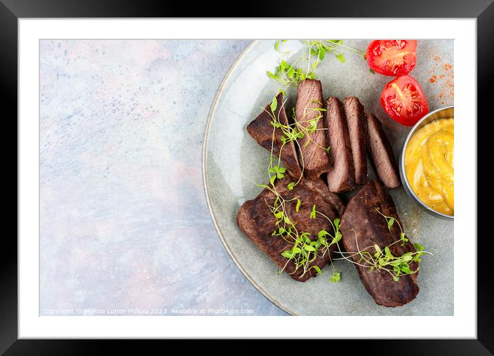 Grilled ostrich steak with sauce Framed Mounted Print by Mykola Lunov Mykola
