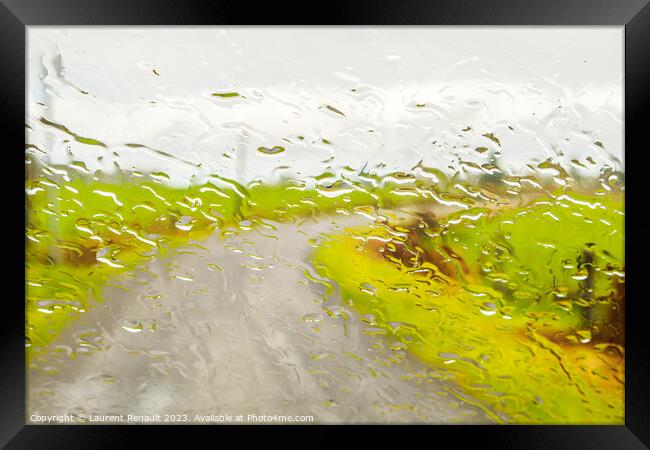Abstract image of rural road, through the wet window Framed Print by Laurent Renault