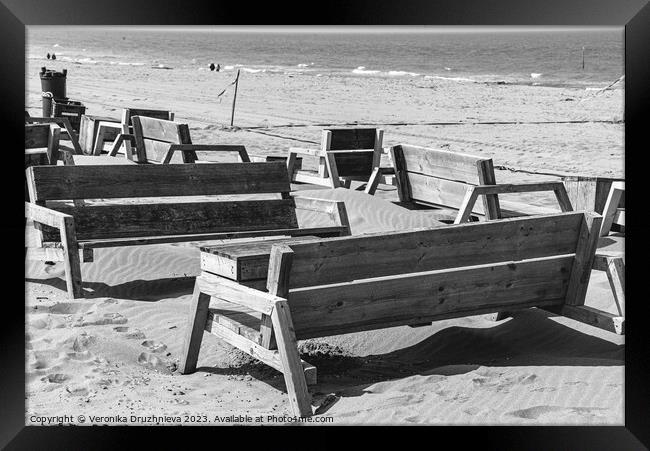 Wodden benches on the beach on Den Haag Framed Print by Veronika Druzhnieva
