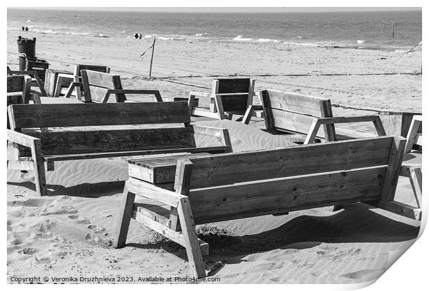 Wodden benches on the beach on Den Haag Print by Veronika Druzhnieva