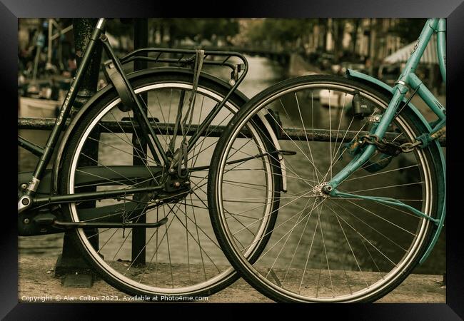 Close up of two bicycle wheels Framed Print by Alan Collins