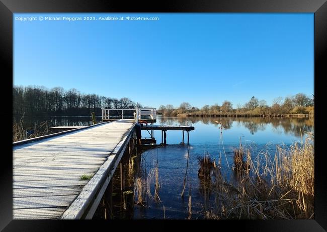 Beautiful landscape on a jetty by a lake with blue sky. Framed Print by Michael Piepgras