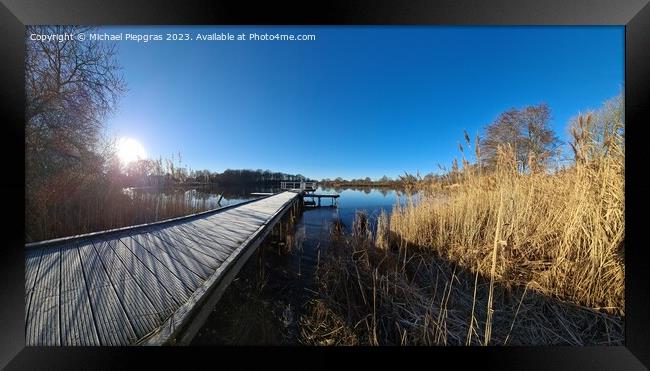 Beautiful landscape on a jetty by a lake with blue sky. Framed Print by Michael Piepgras