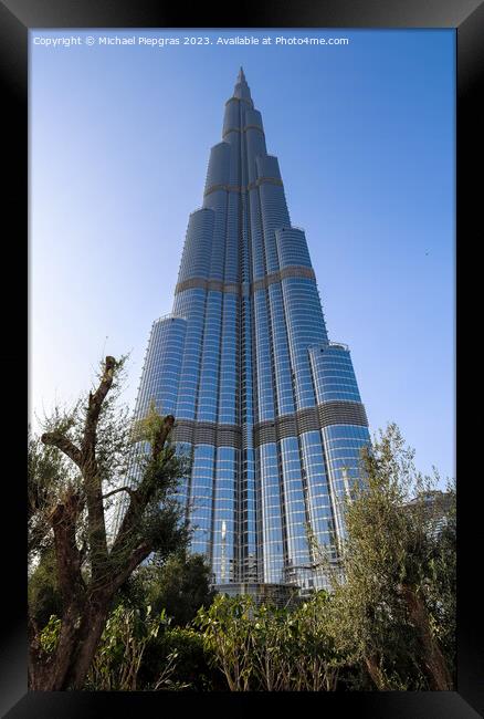 View at the Burj Khalifa on a sunny day. Burj Khalifa is currently the tallest building in the world, at 829.84 m (2,723 ft) Framed Print by Michael Piepgras