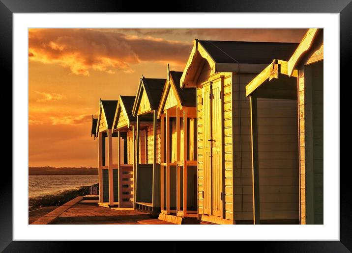 Beach hut sunset reflections over Brightlingsea  Framed Mounted Print by Tony lopez