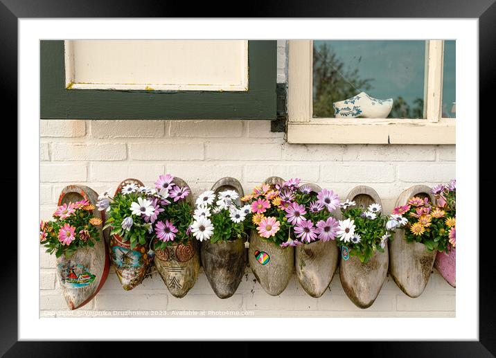 Clogs with flowers under the window Framed Mounted Print by Veronika Druzhnieva