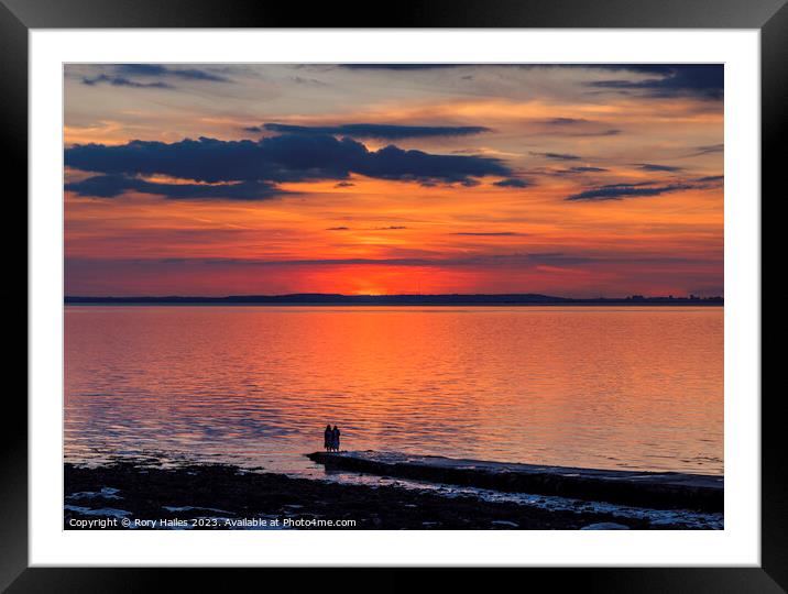 Sunset over the Bristol channel with reddish reflection in the sky and reflecting onto the sea Framed Mounted Print by Rory Hailes