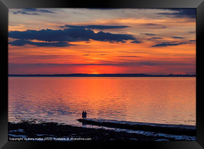 Sunset over the Bristol channel with reddish reflection in the sky and reflecting onto the sea Framed Print by Rory Hailes