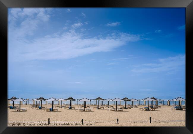 Beach with no one in the Algarve, in spring, with modern umbrell Framed Print by Joaquin Corbalan