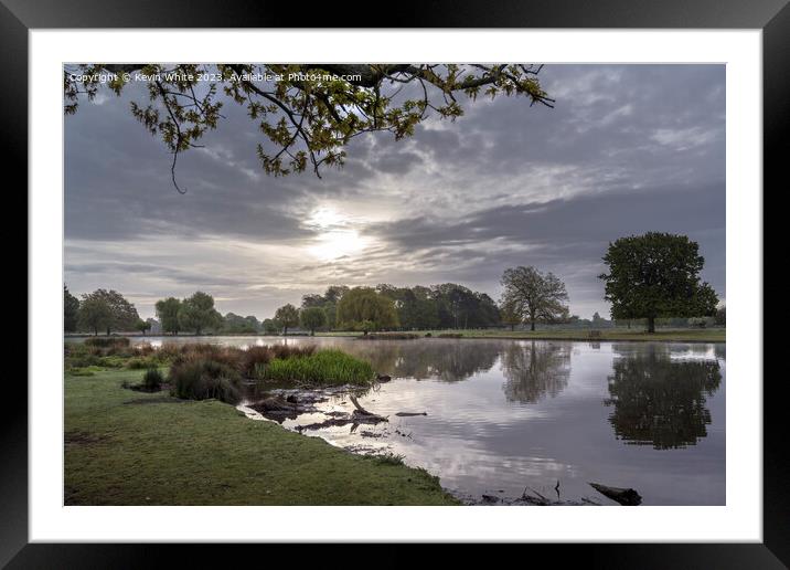 Sun breaking through the stormy skies Framed Mounted Print by Kevin White