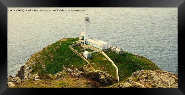 South Stack lighthouse from the cliff Framed Print by Mark Chesters