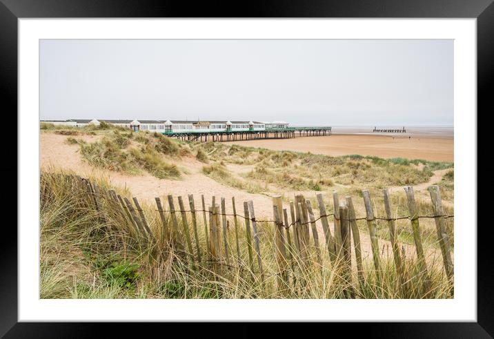 Beach fence in front of St Anne's Pier Framed Mounted Print by Jason Wells