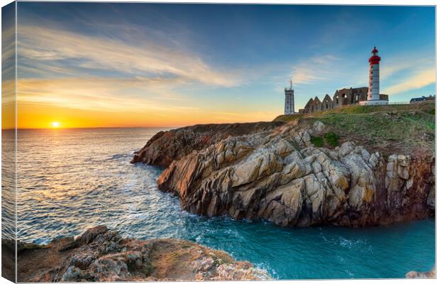 Sunset over the lighthouse at Pointe Saint Mathieu Canvas Print by Helen Hotson