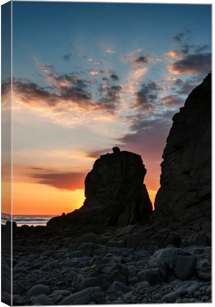Sun Setting behind a Rock Stack Canvas Print by Kevin Howchin