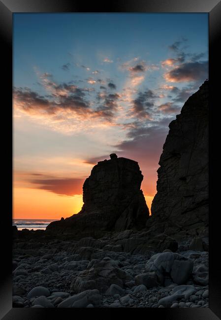 Sun Setting behind a Rock Stack Framed Print by Kevin Howchin