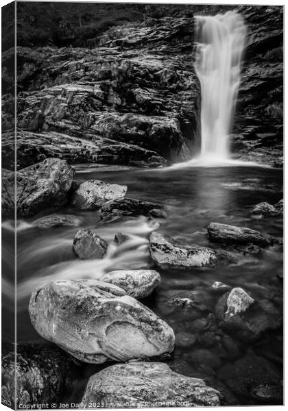 Majestic waterfall surrounded by rocky terrain Canvas Print by Joe Dailly