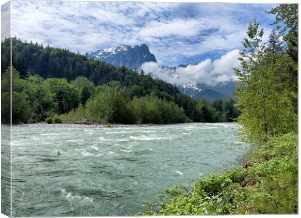Skykomish river with cascade mountains in background of Washingt Canvas Print by Thomas Baker