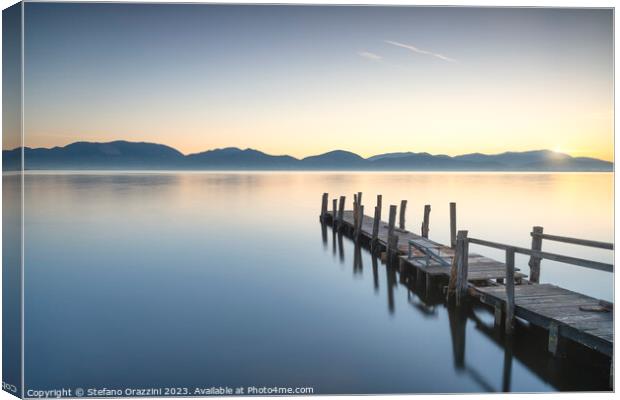 Wooden pier on the lake at sunrise. Torre del Lago Puccini Canvas Print by Stefano Orazzini