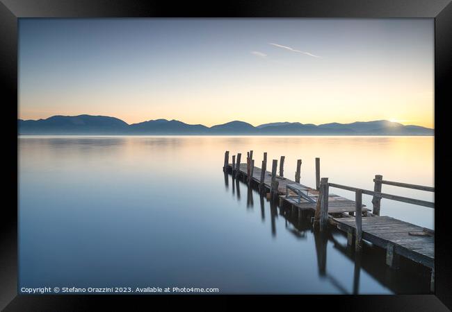Wooden pier on the lake at sunrise. Torre del Lago Puccini Framed Print by Stefano Orazzini