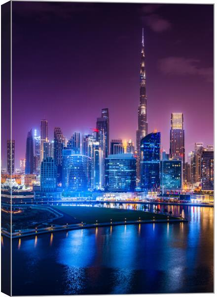 Glowing Dubai Skyline at Night Canvas Print by Steve Heap