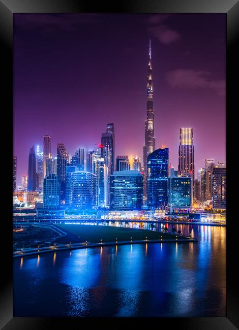 Glowing Dubai Skyline at Night Framed Print by Steve Heap