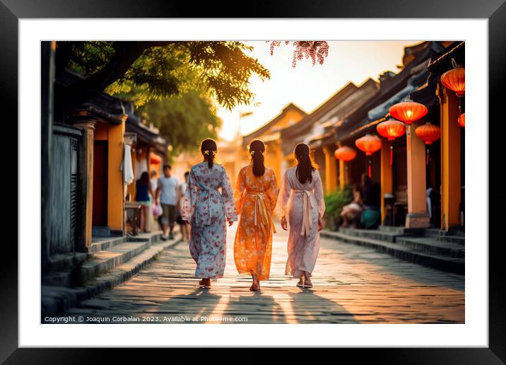 Two young girls in traditional Vietnamese dress walk down a stre Framed Mounted Print by Joaquin Corbalan
