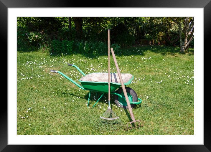 Wheelbarrow with lawn rake and claw cultivator Framed Mounted Print by aurélie le moigne