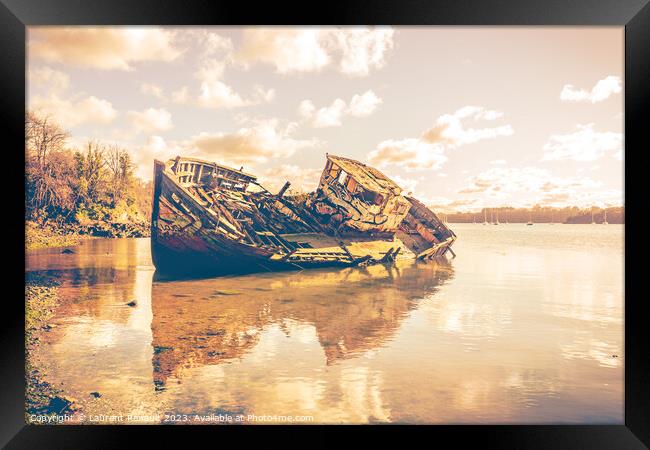 Wreck of a wooden fishing boat abandoned on the shore Framed Print by Laurent Renault