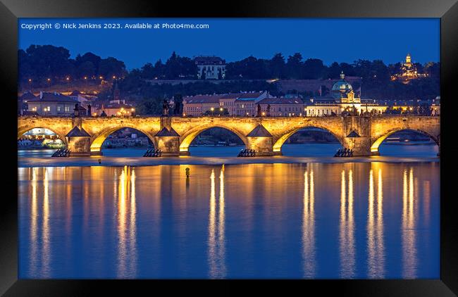 The Charles Bridge lit up over the Vltava River  Framed Print by Nick Jenkins