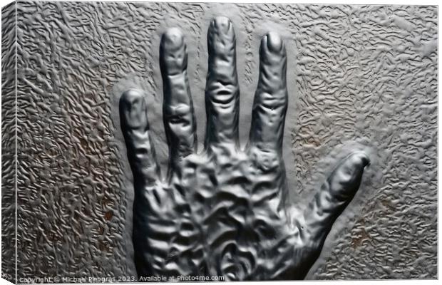 Metal surface background with the relief imprint of a human hand Canvas Print by Michael Piepgras