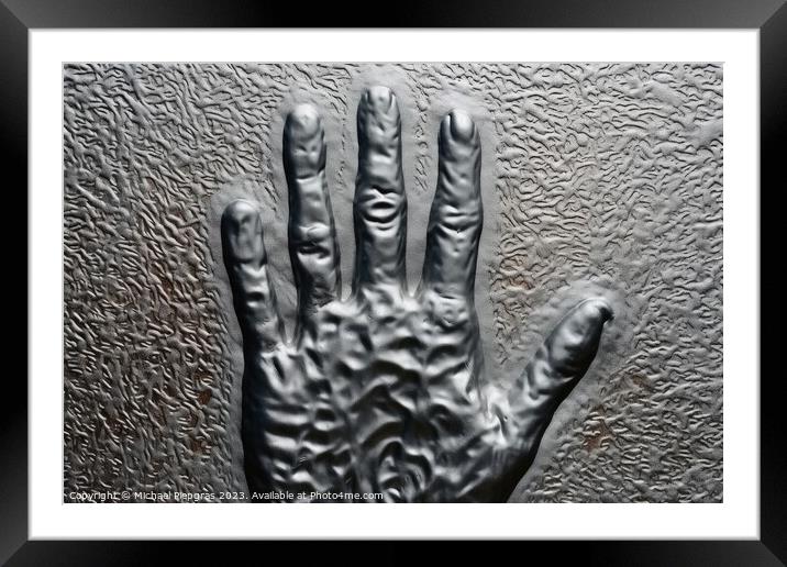 Metal surface background with the relief imprint of a human hand Framed Mounted Print by Michael Piepgras