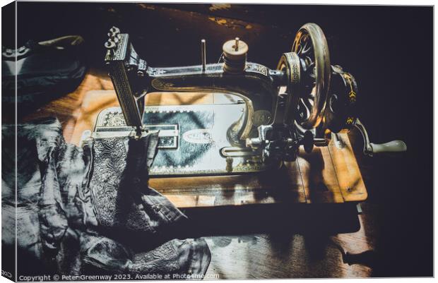 Hand Cranked Vintage Sewing Machine Sunlit On A Wo Canvas Print by Peter Greenway