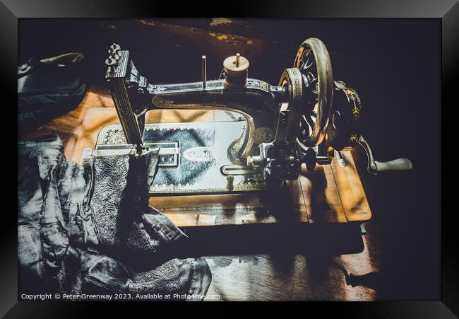 Hand Cranked Vintage Sewing Machine Sunlit On A Wo Framed Print by Peter Greenway