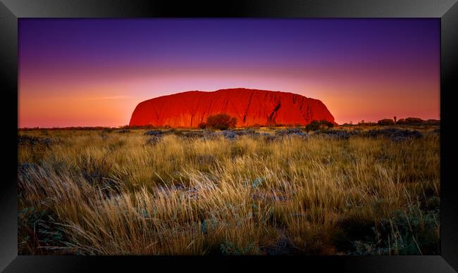 Fiery Skies over Uluru Framed Print by John Frid