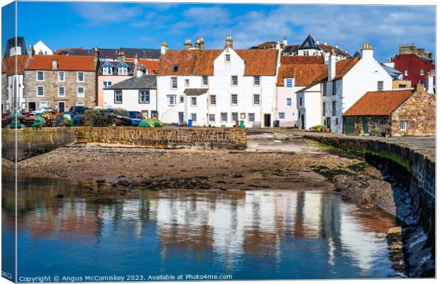 Whitewashed stone houses on Pittenweem harbour Canvas Print by Angus McComiskey