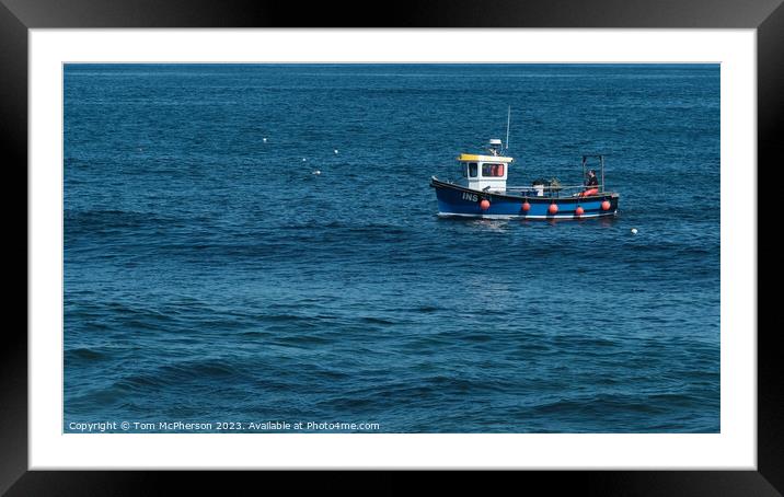 Lone boat in tranquil sea Framed Mounted Print by Tom McPherson