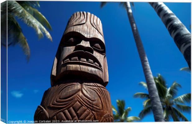 Tiki sculpture engraved in the wood Hawaiian religious motifs. A Canvas Print by Joaquin Corbalan