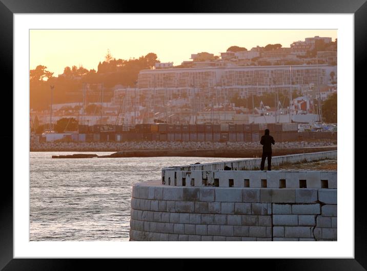 Silhouette of a man standing at the coast of Lisbon Framed Mounted Print by Lensw0rld 