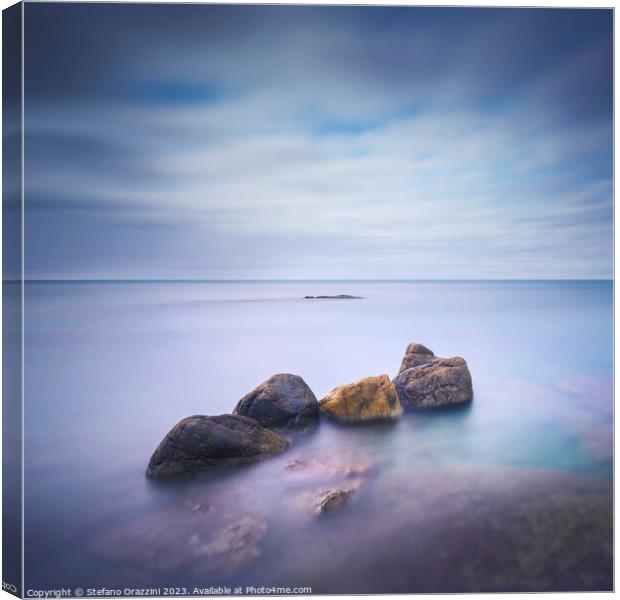 Four Rocks in the Sea. Long exposure photograph Canvas Print by Stefano Orazzini
