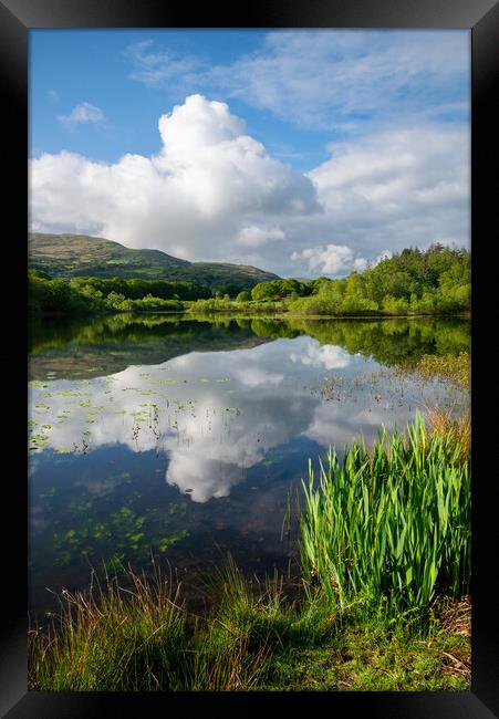 Reflections on a lake in North Wales Framed Print by Andrew Kearton