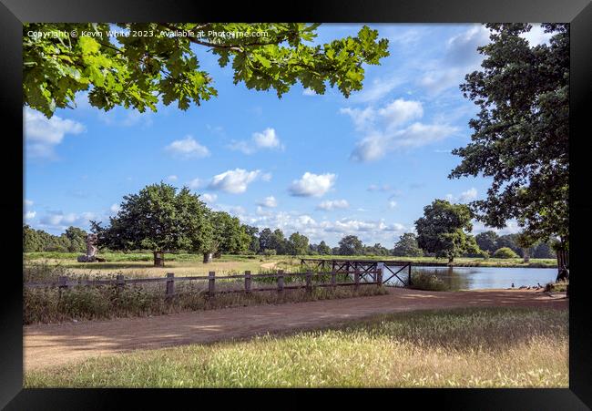 Dappled clouds on a summers morning at Bushy Park ponds Framed Print by Kevin White